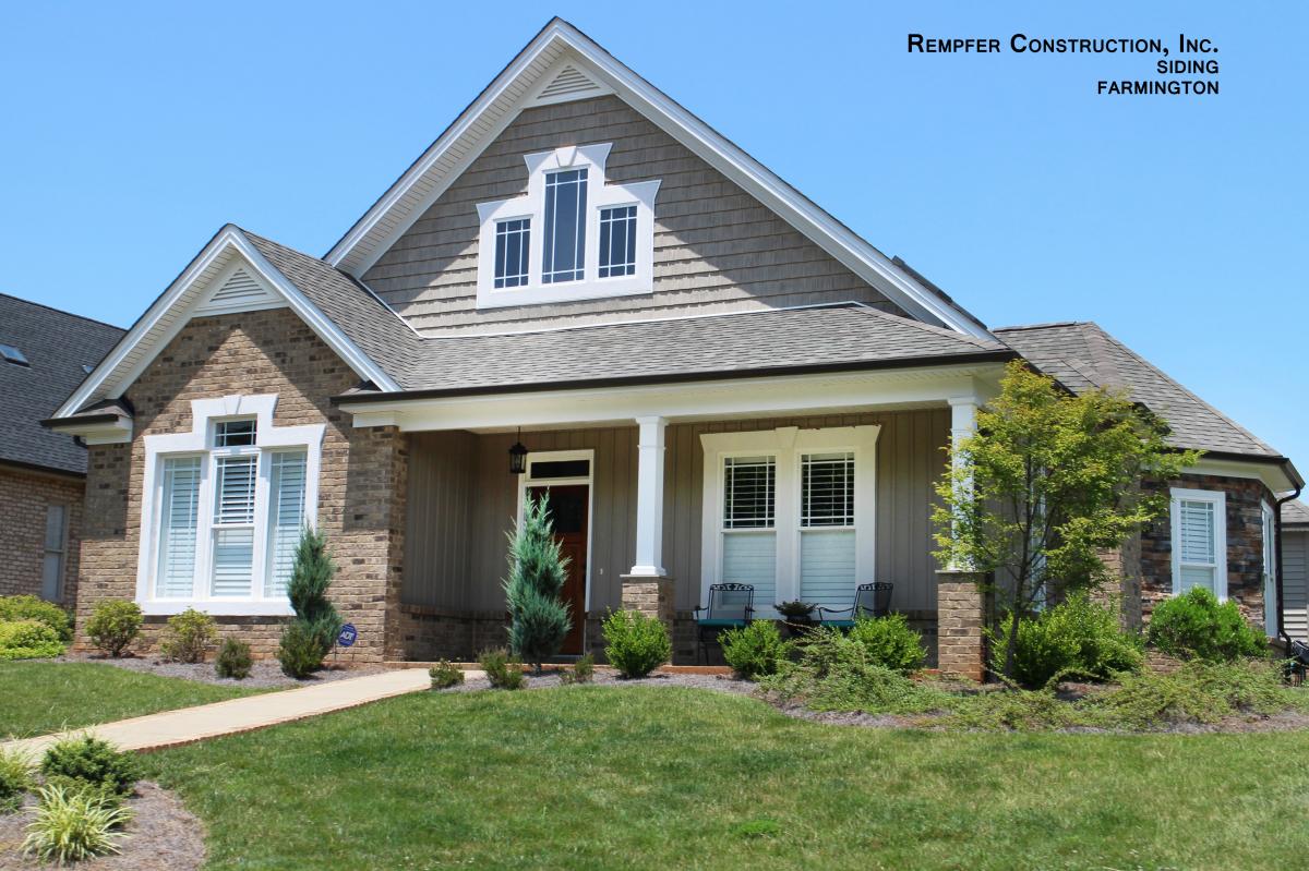 Newly installed stone veneer and tan shake siding